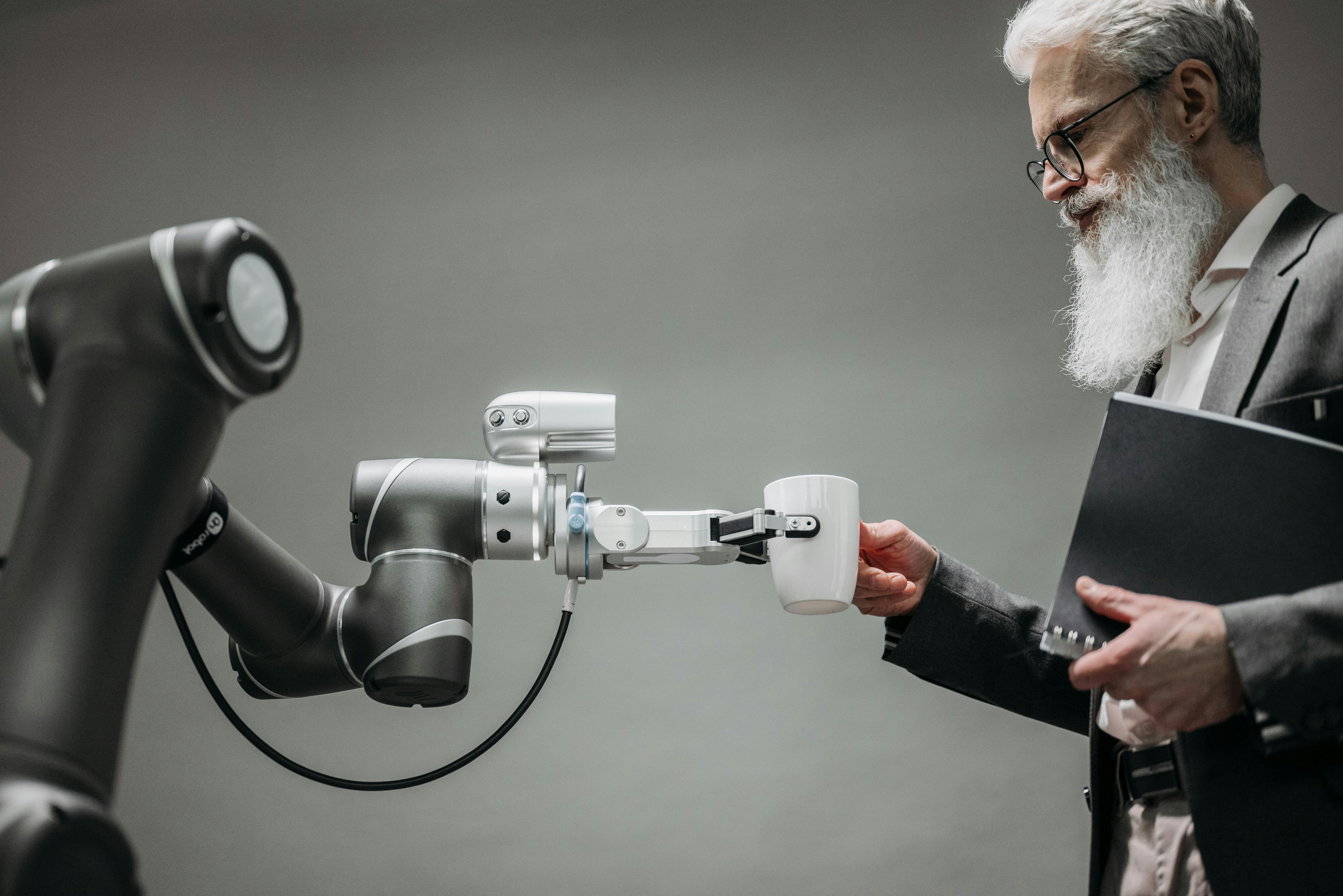ROBOT HANDING COFFEE TO RESEARCHER